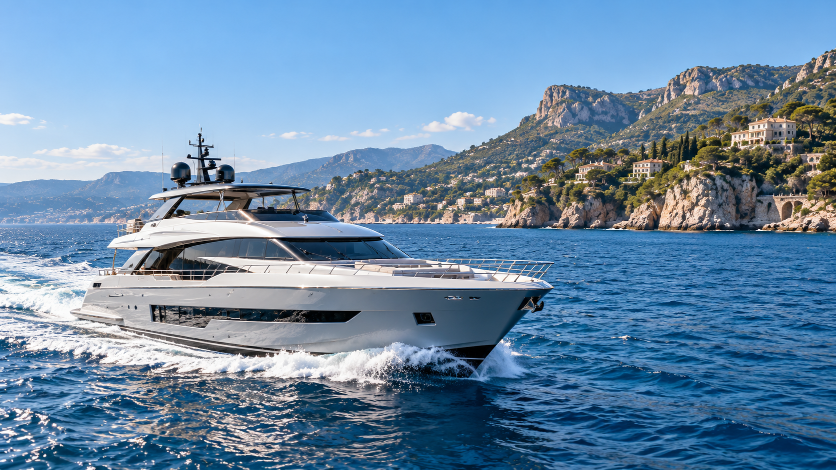 Luxury yacht underway along a Mediterranean coastline